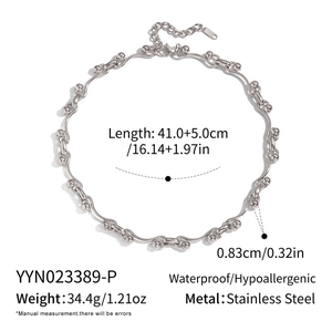 Macro shot of silver stainless steel necklace with ball beads and wavy links design