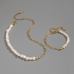 Detail of baroque pearl and gold paperclip chain necklace and bracelet jewelry set