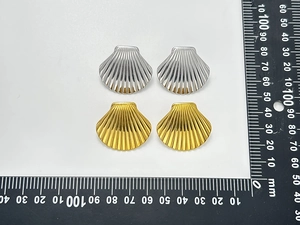 Detailed view of 25mm shell shaped stainless steel stud earrings in gold and silver