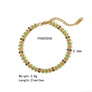 Detail of 18K gold-plated stainless steel leaf bracelet with green enamel inlays