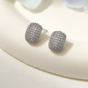 Detail of s925 silver needle geometric earrings featuring pave-set cubic zirconia crystals