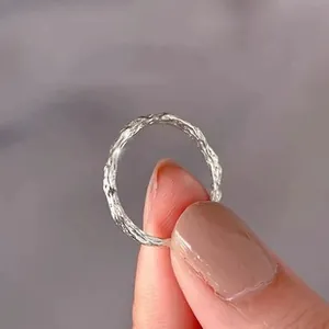 Close-up of silver adjustable ring with natural lava texture and shimmering star details