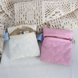 Quilted heart zip pouches in white and pink showing compact storage for small items