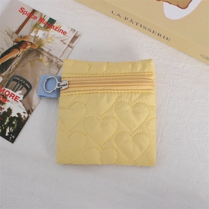 Quilted heart coin purse in bright yellow featuring a sky blue lanyard and silver ring