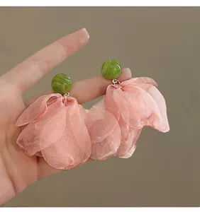 Detail of floral earrings with pink chiffon petals and green agate texture beads