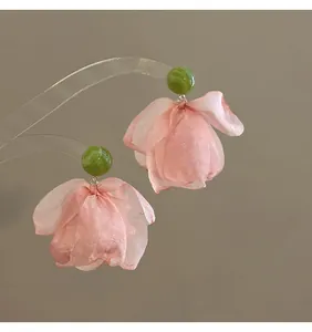 Detail of French vintage floral drop earrings with pink chiffon petals and green marble stud