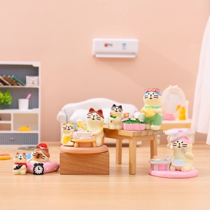 Detailed macro shot of miniature resin cat figurines in cozy home scenes for desk decor
