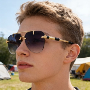 Detail of luxury pilot sunglasses with purple gradient lenses and textured metal temples