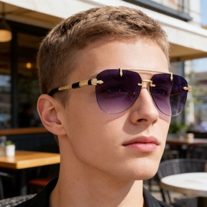Close-up of purple gradient rimless aviator sunglasses with gold metal frame detailing