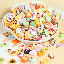 Macro shot of assorted colorful resin DIY food and animal miniature accessories in a bowl