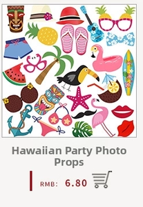 Macro shot of tropical party photo props including Tiki masks, flamingos and pineapples