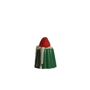 Realistic strawberry pudding scented candle with green base and white cream dripping