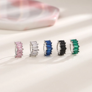 Row of silver cuff earrings with colorful rectangular zircons in five vibrant shades