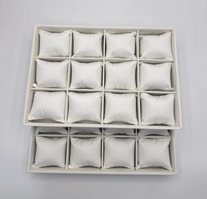 Detail view of 12-slot white velvet jewelry display trays with soft watch pillows