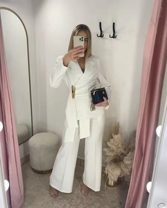 Mirror selfie showing white blazer suit with gold buckles and wide-leg trousers