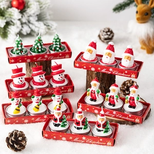 Christmas candle set with Santa and snowman figures in festive gift packaging