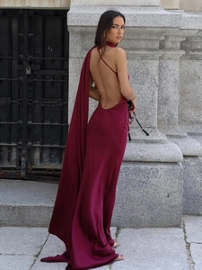Elegant burgundy satin halter maxi dress with backless design and flowing neck ribbons