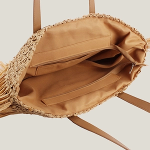Spacious woven straw tote bag with brown interior lining and a secure zipper compartment