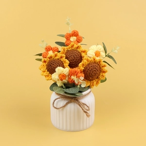Handmade crochet sunflower and daisy potted plant in white ceramic vase with ribbon