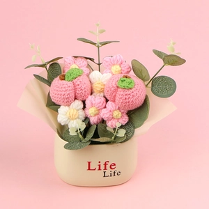 Detail of handmade crochet sunflower fruit bouquet in white pot with Life Life text