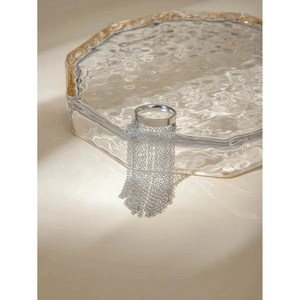 Detailed macro view of silver fringe tassel ring with delicate hanging metal chains