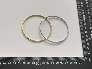 Detailed measurement view of minimalist gold and silver stainless steel bangles with scale