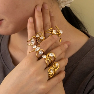 Detailed view of 18K gold plated stainless steel rings with zirconia on model hands