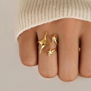 Elegant 18K gold starburst ring for women featuring triple star charms on fingers