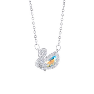 Close-up of a silver swan necklace with white zircons and an AB color crystal stone