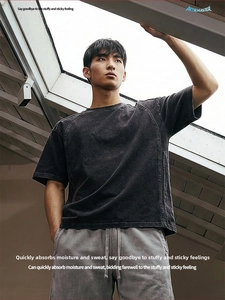 Detail of acid wash texture on men's cotton t-shirt with raw edges and distressed finish