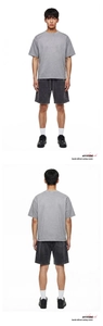 Detailed texture of faded grey acid wash fabric on retro oversized casual shorts
