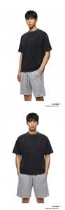 Detail of vintage washed cotton T-shirt with raw edges and drawstring shorts set