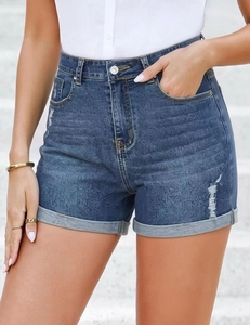 Detail of high-waisted dark blue denim shorts featuring floral jacquard and cuffed hems