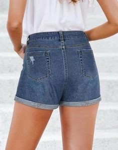 Detailed back view of high-waisted dark blue denim shorts with rolled hems and distressed pockets
