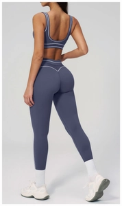 Détail de l'ensemble de yoga bleu foncé avec doubles rayures blanches et coupe dos en V