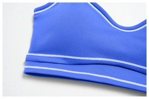 Close-up of royal blue sports bra with white decorative stitching and high-stretch fabric