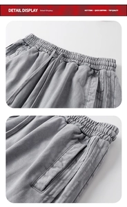 Detail of grey washed cotton shorts with elastic drawstring waist and side pockets