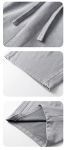 Detail view of high-quality grey knitted fabric with flat drawstrings and fleece texture