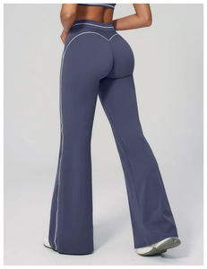 Detail view of high-waist flared yoga pants with white contrast piping and V-shape lifting seam