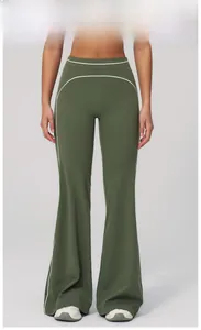 Detail of moss green flared yoga pants with white side stripes and high waist design