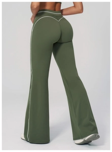 Detail of high waist flare leggings in dark green with contrast white piping and wide leg