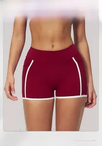 Detail of high-waisted burgundy yoga shorts with white contrast stripes for fitness