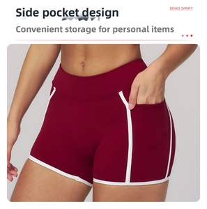 Detail view of red high-waisted yoga shorts with white side piping and functional pockets
