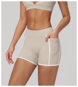 Close-up of high-waisted fitness shorts with functional side pocket and white piping