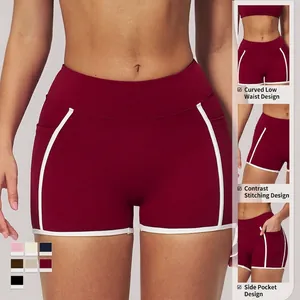 Women's burgundy yoga shorts with white contrast trim and functional side pockets