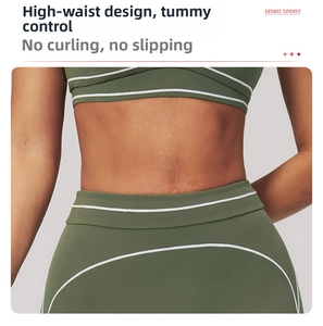 Detail of high-waisted olive yoga pants with white contrast stitching for tummy control