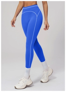 Detail view of electric blue high-waisted leggings with white contrast stitching for yoga