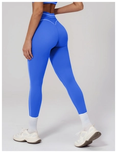 Close-up of high-waist yoga leggings featuring blue fabric and white stripe detail