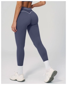 Detail view of high-waist yoga leggings with white V-shaped stitching and body shaping effect