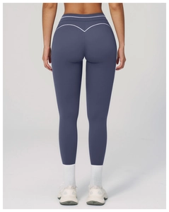 Detail of high-waisted yoga pants featuring a white V-shaped back seam for contouring
